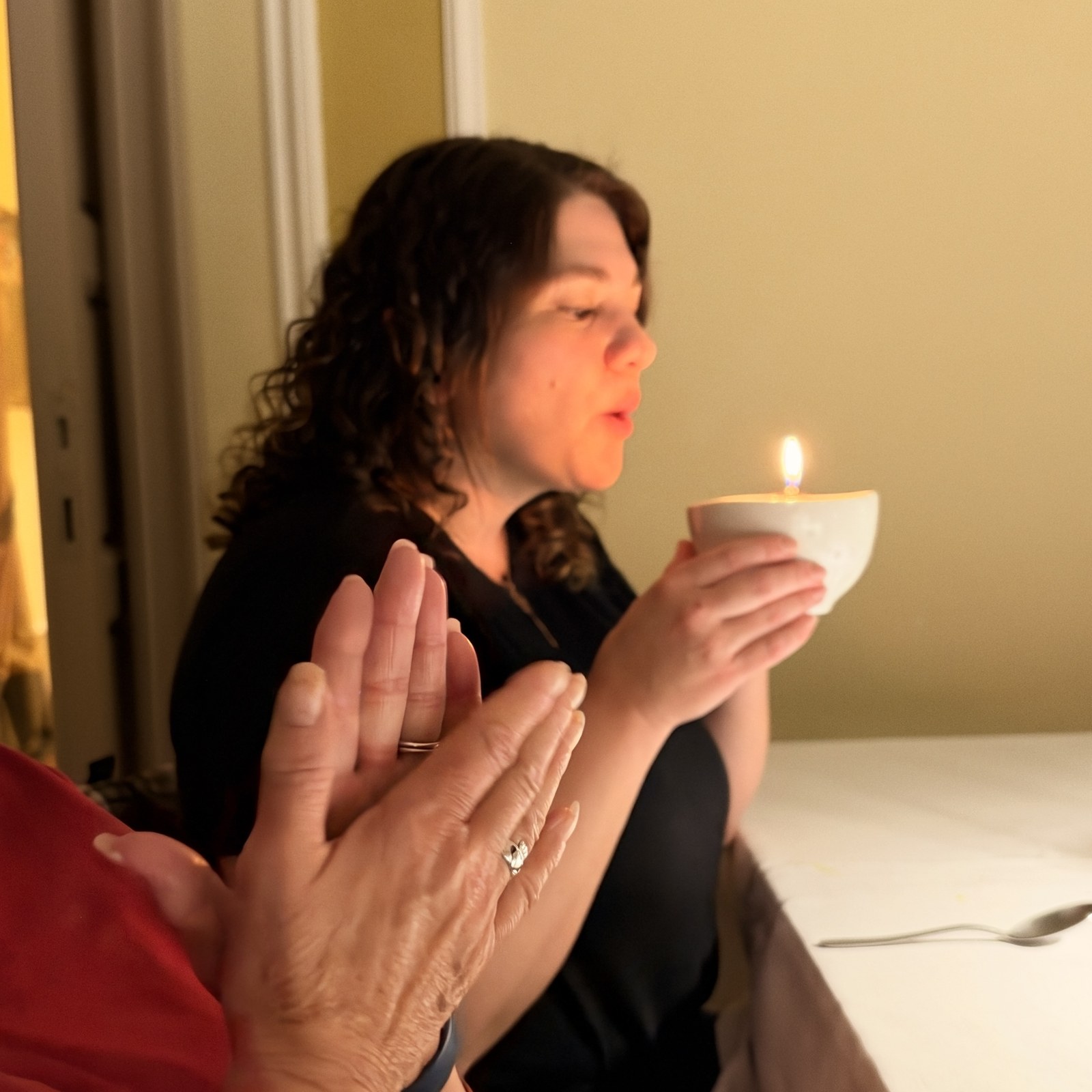 A guest blowing out the birthday candle on her dessert dish at Castello La Leccia